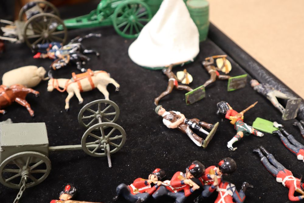 A collection of painted Britains and Holocast lead soldiers, artillery pieces, including some rare dated including Scots Guards chargin